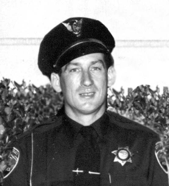 Historic black-and-white portrait of a Tracy police chief in uniform and a peaked cap.